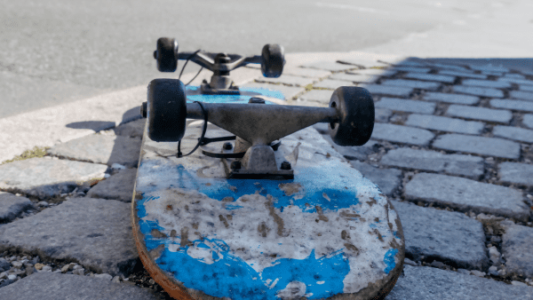 A skateboard on the road upside down.