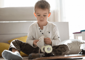 A kid is wiping a rusty skateboard