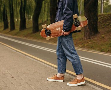 Person holding a skateboard.