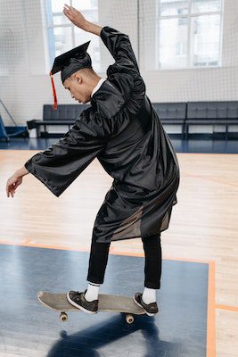 student riding a board inside the school gym