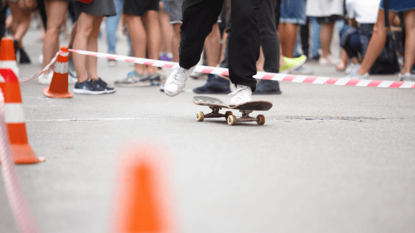 Silhouetted skateboarder performing a kickflip against a vibrant urban backdrop, capturing the dynamic and energetic essence of skating in an urban environment.