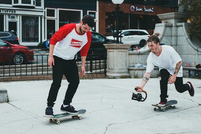 two men skateboarding and recording