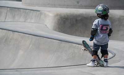 A kid with skateboard gear. Skateboard to practice for skateboarding. 