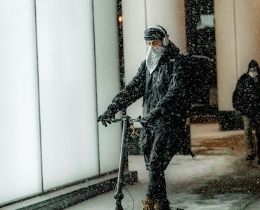 Man riding a scooter during the winter season