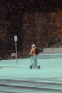 Child riding a scooter during the winter season