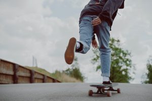 street skateboarding: a kid is happily riding in the city road