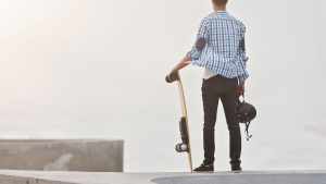 A man looks out holding a board