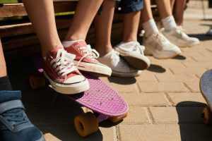 The best skateboards for kids: Group of kids sitting on the bench, enjoying a sunny day. The cutest skateboards for kids