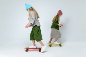 girl one-one-on with skateboarding together, having fun and beneficial