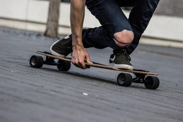 Man on a skateboard having an exhilarating time while performing skateboard tricks guided by experience.