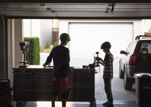 two little boys fixing their decks with a tool. A tool kit is helpful. 