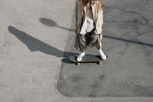 A woman rides her skateboard confidently. 