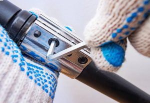 A person is adjusting the fork of the scooter.