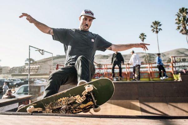 Image of a man performing stunts on a half-pipe. Professional skateboarders have had a major impact, leaving an indelible mark and inspiring countless others with their dedication and prowess.