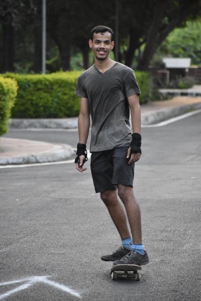 A happy man riding his skateboard