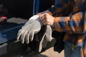 A man wearing his scooter gloves.