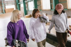 Skateboarding enthusiasts with their different skateboards.