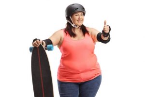 woman in orange clothes full of smiles as she is ready for ride