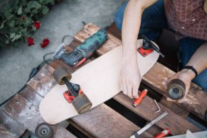 Technician is fixing a longboard bearing for effortless riding experience.