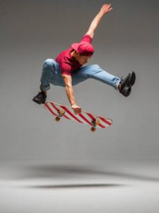 A man practicing trick with his skateboard, getting ready for a competition and for winning