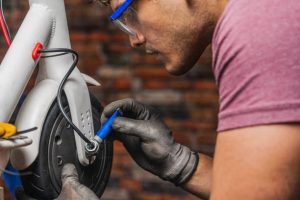 An owner is trying to do DIY repair a scooter. 