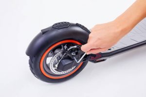 The rider is adjusting the scooter fork. The scooter fork also absorbs some of the shocks and vibrations from the road, making the scooter ride smoother and more comfortable. The scooter fork consists of several parts, such as the steerer tube, the crown, the legs, and the axle.