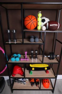 skateboard racks with different balls, skateboard, and skateboarding gears.