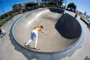 girl practicing skateboard tricks 