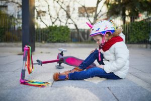 A girl with a colorful scooter