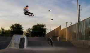 A man is doing a trick using a longboard. 