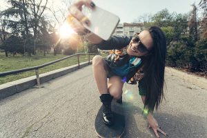 The skateboarding woman captures a spotlight moment.