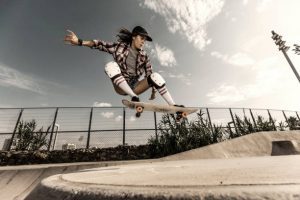 Skateboarding Benefits: A skateboarder benefits from the physical activity while performing a trick at a skate park.