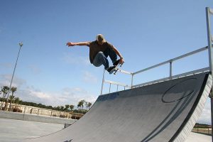 A man with a cap and longboard