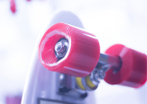 A well-maintained quality skateboard with pink skateboard wheels and silver truck is newly-lubricated for proper functioning. 