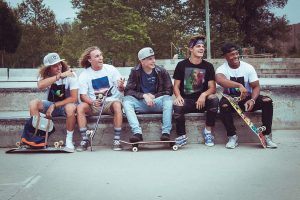 striking a pose after an exciting skateboarding group lessons. 