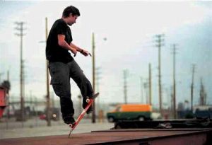 A skater performing a skateboard trick with his skateboard