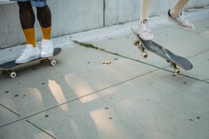 Two persons skateboarding outdoors