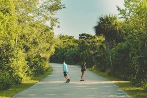 People riding their electric boards with the right speed while enjoying the ride and view.