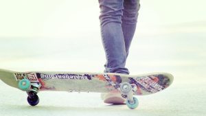 A close-up shot of a feet playing with skateboards in an event.