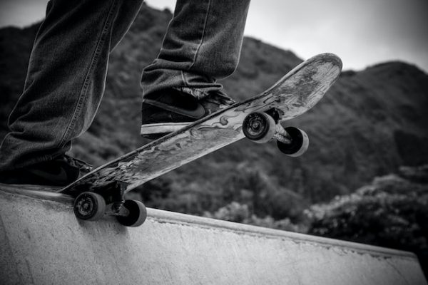 A person practicing skateboarding tricks on a half pipe.