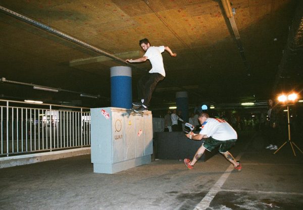 These skateboarders are doing stunts in the industry, the streets, and the open roads