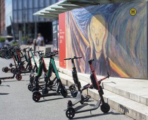 A bunch of best scooters that are lined up in the street. They are the best travel scooter and is neatly parked in a designated downtown scooter area, surrounded by other best ones, all awaiting their respective owners, creating a convenient and efficient urban mobility hub.