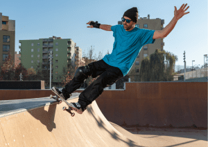 A rider is doing slide tricks on an elevated or inclined surface. 