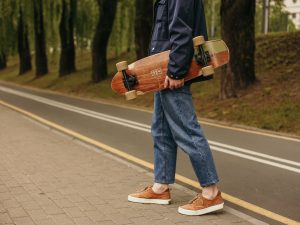 Skateboards Apparels - integral to elevating your experience and ensuring safety while you push your limits on the board. man holding a board near the road wearing comfortable clothing