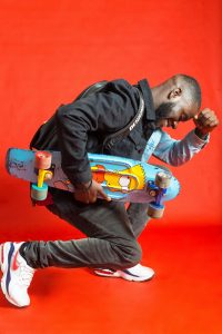 A man is holding a colorful skateboard