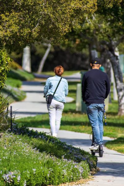 A man and a woman riding down a pathway