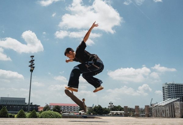 A man doing tricks using his skateboard