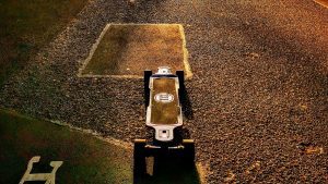 A waterproof electric skateboard basks serenely in the vibrant sunset, casting a mesmerizing reflection. 