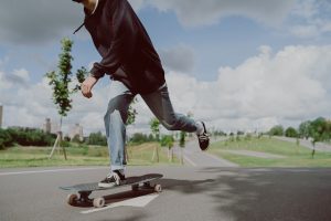 A skateboarder riding a skateboard down the road.