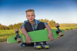 A boy with his skateboard.